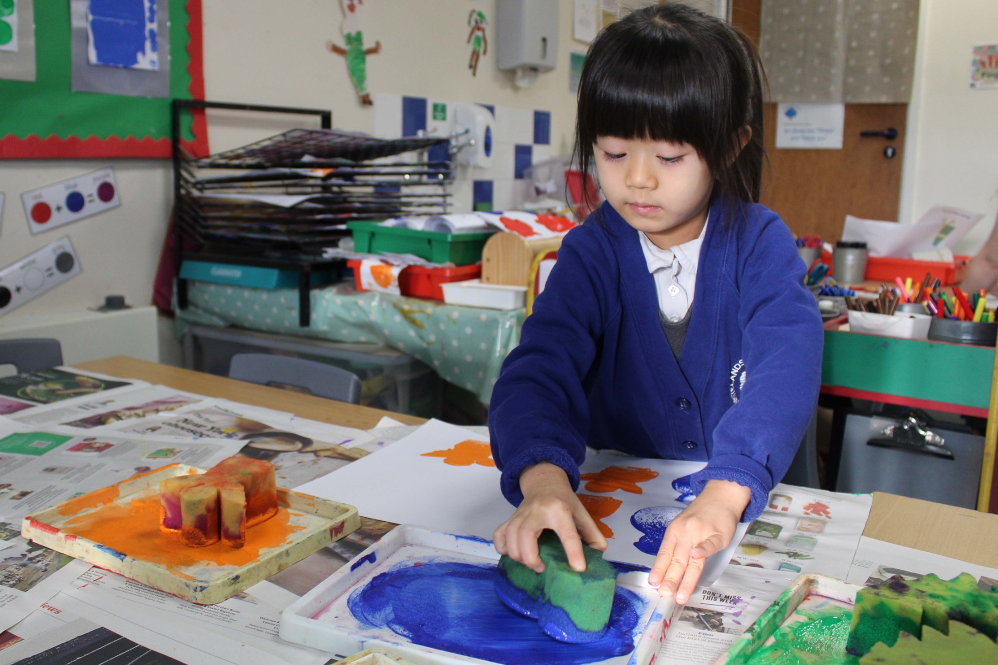 Whitelands Park pupil painting with watercolours in a classroom art activity.