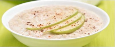 Bowl of Porridge with sliced apple on top